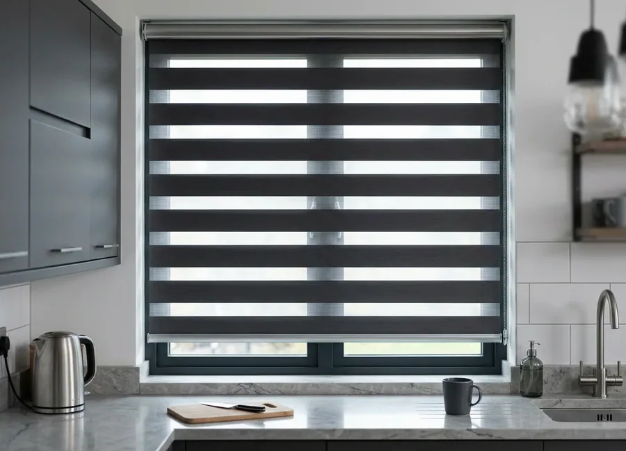 Day and night blind half-lowered in an Illovo bedroom at dusk with city lights beginning to glow